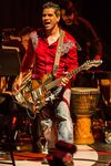 Image of Tommy Tallarico playing a guitar on stage 