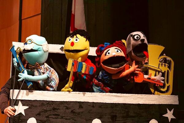 Four hand puppets on a stage 